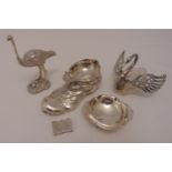 A quantity of white metal to include a pill box, bonbon dishes, a model of a boot and a figurine