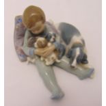 Lladro figurine of a young boy with puppies and a dog, marks to the base 18cm (w)