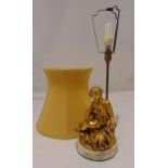 A gilded composition table lamp in the form of a classical female figurine on raised circular marble