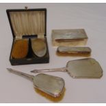A quantity of silver to include a cigarette box, a hand mirror and brushes (6)