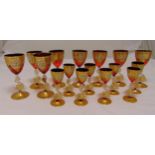 A set of eight Murano wine glasses, gilt and ruby red decoration with dolphin stems on raised