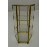 A hexagonal gilded metal and glass miniature display cabinet on four bun feet, 24cm (h)