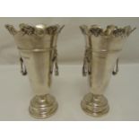 A pair of hallmarked silver vases of tapering cylindrical form, lion mask and ring side handles on