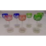 Seven coloured hock glasses, etched bowls, tapering cylindrical stems on circular bases, 20cm (h)