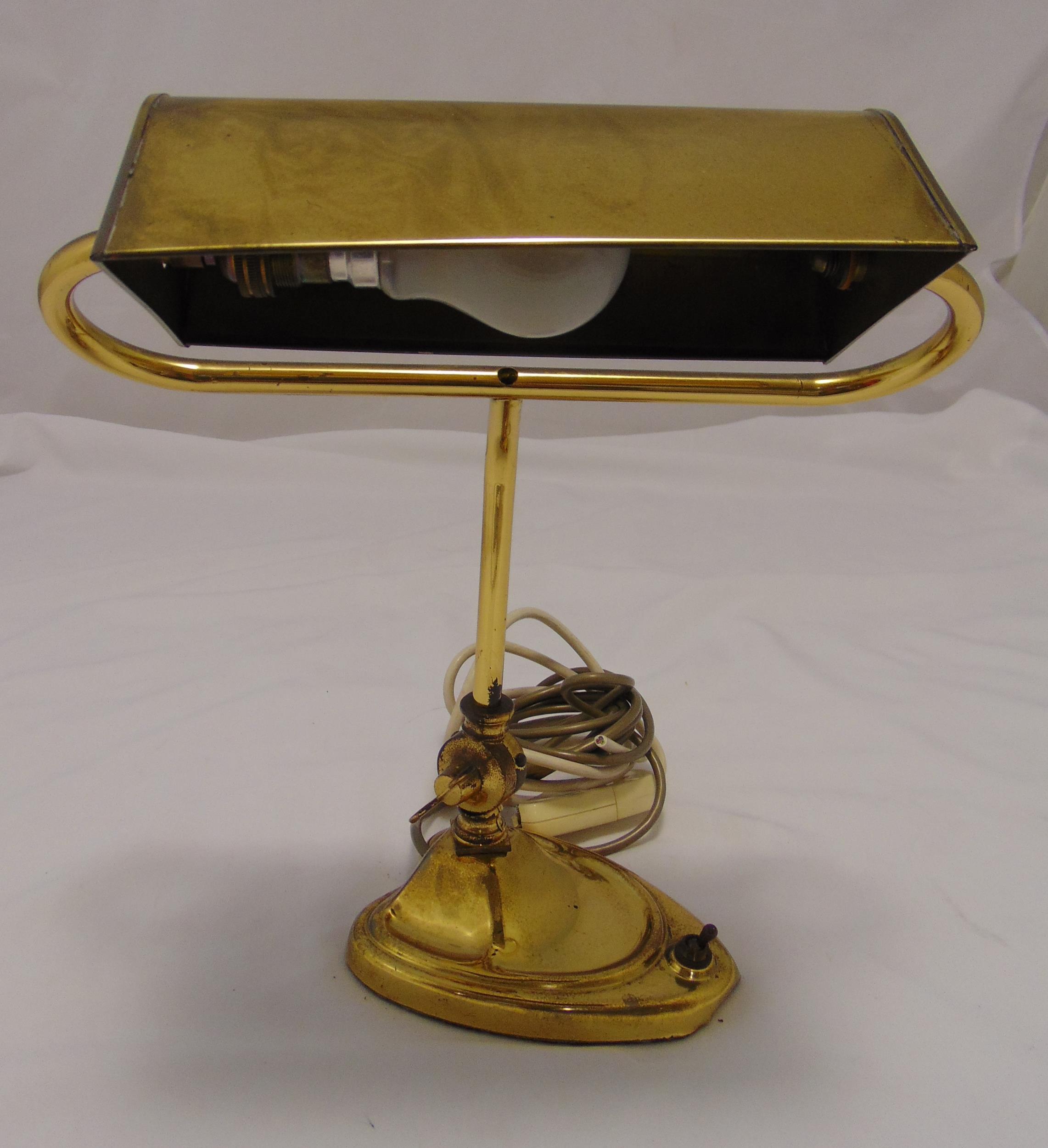 An early 20th century rectangular brass desk lamp on raised shaped oval base, 39cm (h)