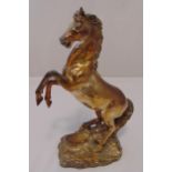 A silver plated figurine of a prancing horse on naturalistic base, 40cm (h)