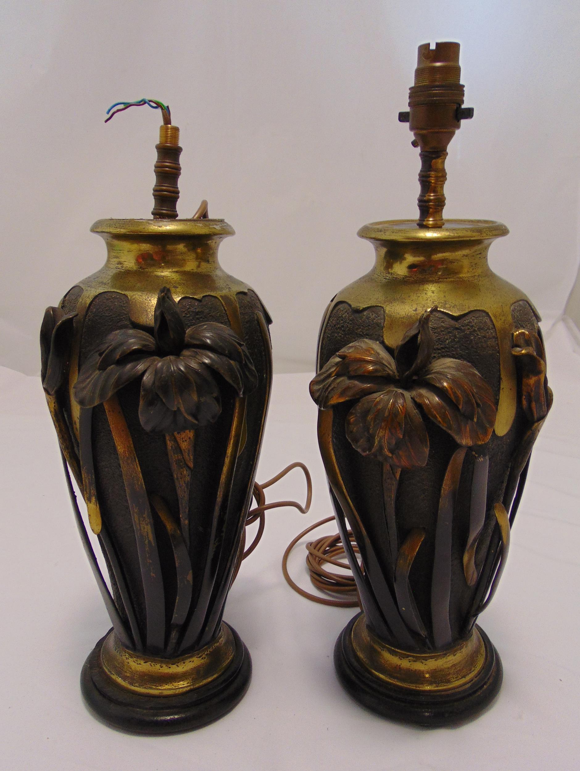 A pair of Art Nouveau style table lamps, copper and brass ovoid form with applied flowers and leaves