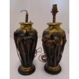 A pair of Art Nouveau style table lamps, copper and brass ovoid form with applied flowers and leaves