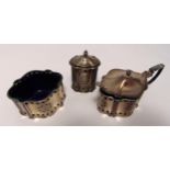 A three piece hallmarked silver condiment set of shaped oval form, pierced sides and beaded borders,