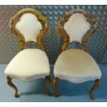 A pair of continental upholstered occasional chairs on scroll legs