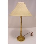 A gilded composition simulated bamboo stem table lamp, on raised circular base with reed and tie