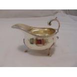 A Victorian hallmarked silver sauce boat with flying double scroll handle, gadrooned border on three