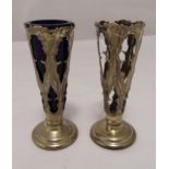 A pair of hallmarked silver vases, tapering cylindrical with scroll pierced sides on raised circular