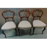 Three Queen Anne style mahogany dining chairs, scroll and pierced carved backs on cabriole legs