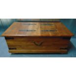 A rectangular wooden chest with metal bands to the sides and hinged top, 46 x 110.5 x 60cm