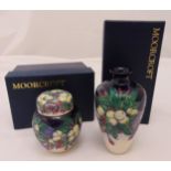 Moorcroft vase and a matching jar and cover decorated with flowers and leaves, marks to the bases,