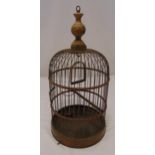 A Victorian bird cage of cylindrical form with turned wooden terminal and detachable copper base,
