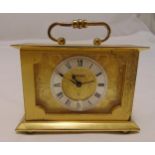 A Swiza rectangular desk clock with Roman numerals, scroll handle on four bun feet, 8 x 11cm