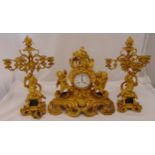 A French 19th century ormolu clock set with candelabra garnitures, the clock supported by putti, the