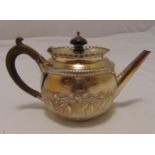 A Victorian hallmarked silver bachelor teapot of compressed spherical form, the sides chased with
