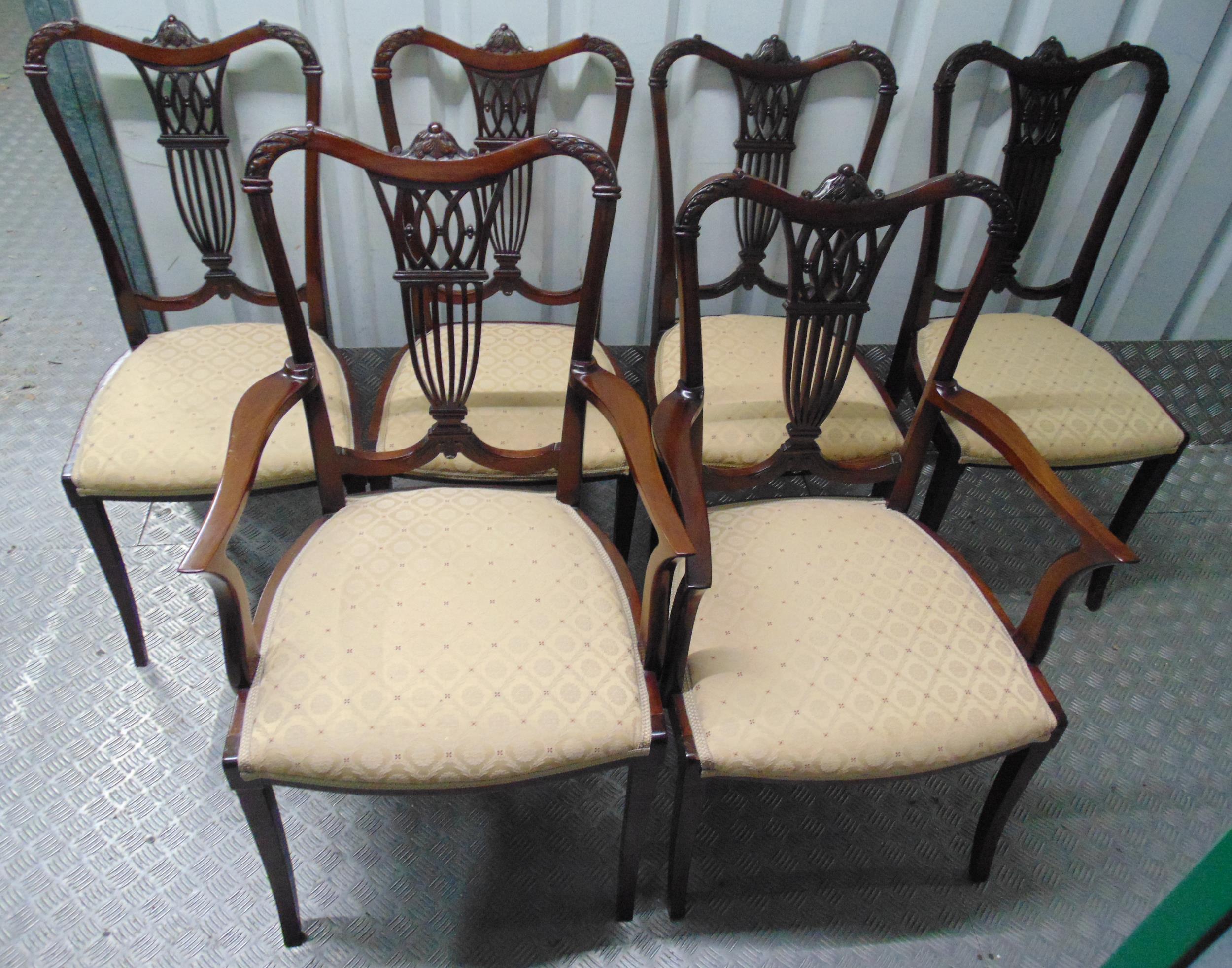 A set of six Edwardian dining chairs, two carvers, carved and pierced backs on tapering