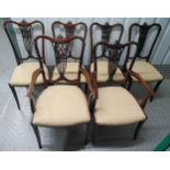 A set of six Edwardian dining chairs, two carvers, carved and pierced backs on tapering