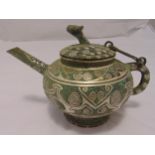A Chinese Archaic bronze wine pot of circular form with angled spout, scroll handle and hinged cover