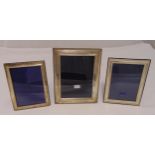 Two hallmarked silver rectangular photograph frames and a white metal photograph frame