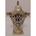 A hallmarked silver sugar bowl, scroll pierced vase form with shell mounted side handles, domed