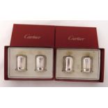 Two pairs of Cartier silver plated salt and pepper in the form of half columns in fitted original