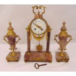 A 19th century French mantle clock, the circular enamel dial with Arabic numerals supported by two