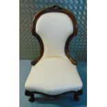 A Victorian ladies mahogany nursery chair with upholstered seat and back on four scroll legs