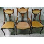 A suite of three Edwardian mahogany occasional chairs with satinwood inlays and upholstered seats