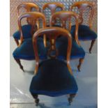 A set of six Victorian mahogany upholstered dining chairs, pierced backs on tapering cylindrical