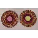 Two Vienna centrepieces of circular form decorated with relief gilding against dark red ground,