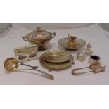 A quantity of silver plate to include a tureen and cover, cake stands, condiments and a soup ladle