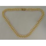 A double strand cultured pearl necklace with a 9ct gold and pearl clasp, 50cm long