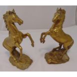 A pair of brass figurines of prancing horses on naturalistic bases. 40cm (h)