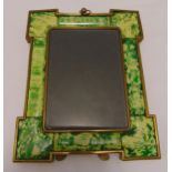 A shaped rectangular brass and composition photograph frame with suspensory loop and hinged back