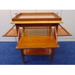 A rectangular French mahogany tea tray table with satinwood inlaid bands and hinged sides, on four