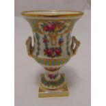 A campagna shaped vase decorated with flowers and leaves with two pierced side handles on raised