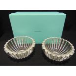 A pair of Tiffany and Co. crystal bowls, circular with lobed sides, etched to the bases to include