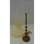 A brass table lamp of knopped cylindrical form on raised circular base and shade, 57cm (h)