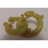 A pair of Chinese celadon jade rings in the form of dragons