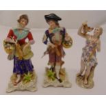 Three continental figurines, holding birds and a hare