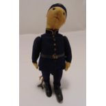 An early 20th century clockwork toy in the form of a uniformed policeman to include a key