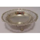 A hallmarked silver cake stand circular scroll pierced sides with scroll border on three scrolling