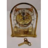 Sewells of Liverpool gilded metal skeleton mantle clock with arched top, silvered dial and Roman