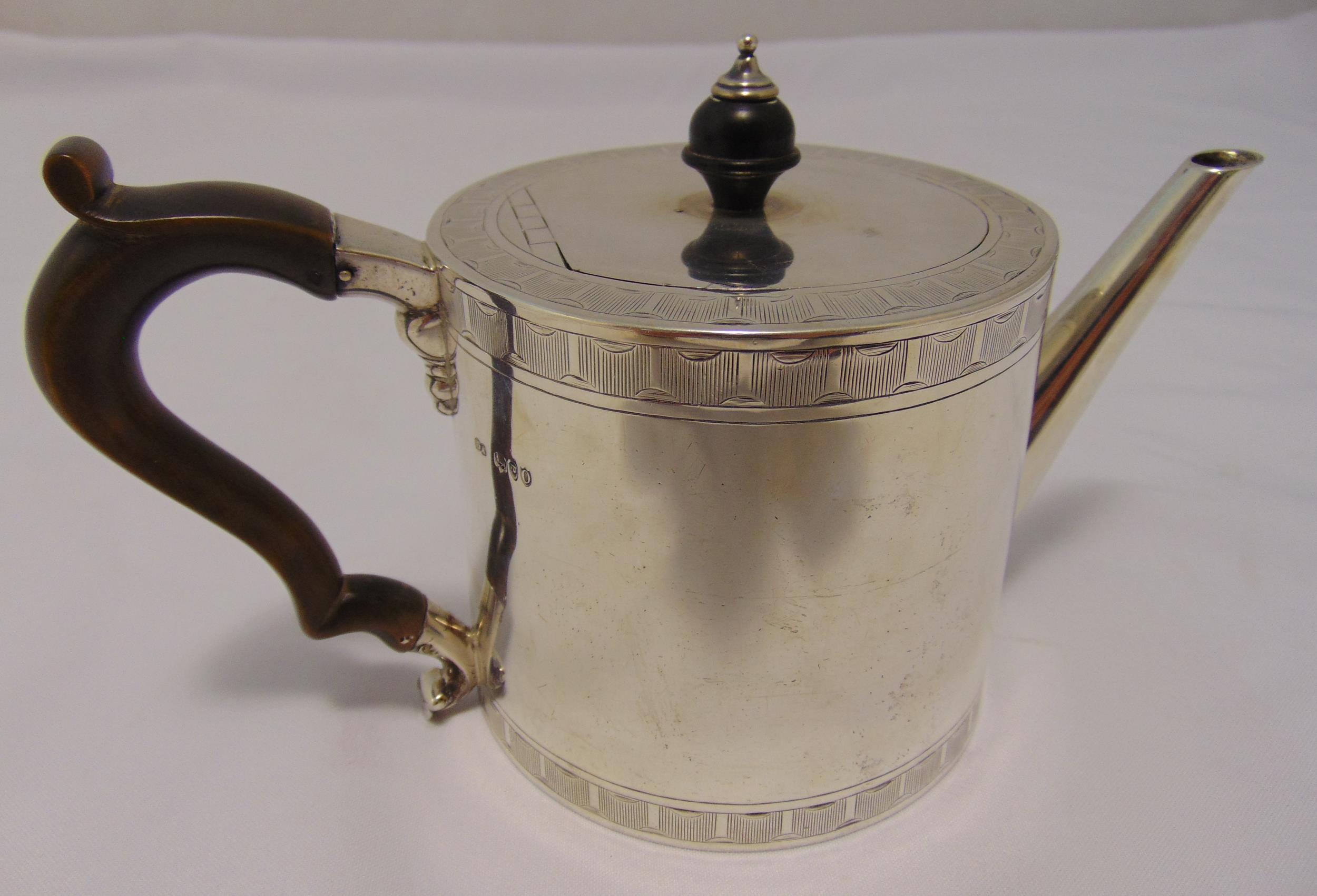 A Victorian hallmarked silver drum teapot, cylindrical with engraved bands the flat hinged cover
