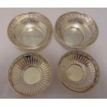 A pair of hallmarked silver nut dishes, circular, bar pierced sides and a pair of similar smaller